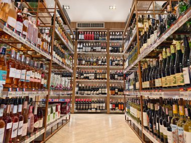 PHUKET, THAILAND - 8 Mart 2025: sayısız çeşitli alkol şişeleriyle dolu bir perakende mağazası.