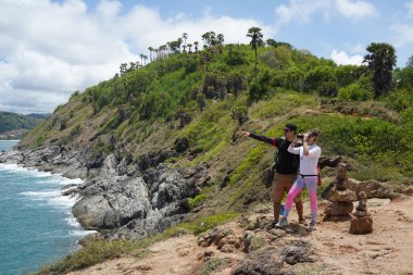 Bir erkek ve bir kadın dikkatle dürbünle uzaktan ilginç bir şeye bakıyorlar..