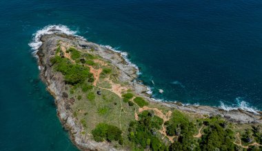Uçsuz bucaksız okyanusun ortasında, mavi sularla çevrili küçük bir ada..