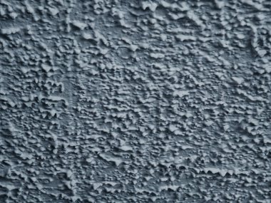 Kalıplı mavi beton duvar yüzeyinin detaylı bir yakın çekimi.