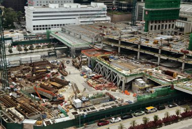Hareketli bir şehirde bulunan bir inşaat alanını gösteren havadan bir perspektif..