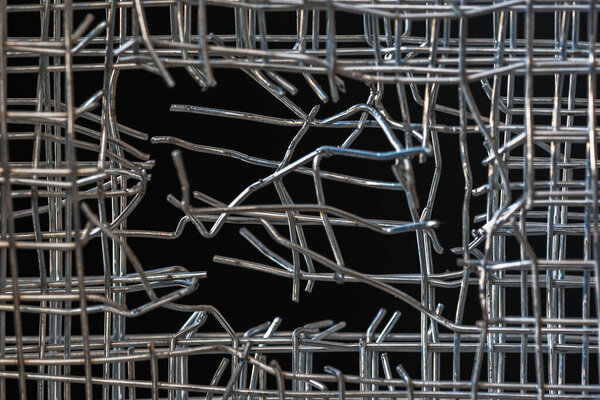 A wire mesh fence as a barrier symbolizes strength, protection, and a concept of breaking boundaries for freedom