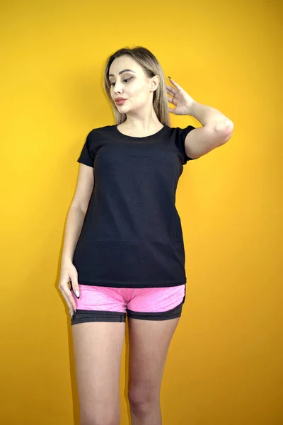 Beautiful Caucasian Lady Posing Black Shirt Sports Shorts Yellow Background — 图库照片