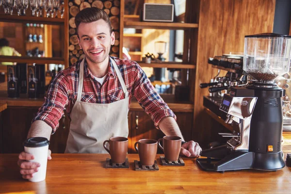 Handsome Young Barista Apron Giving Cup Coffee Looking Camera Smiling — Stock Photo, Image
