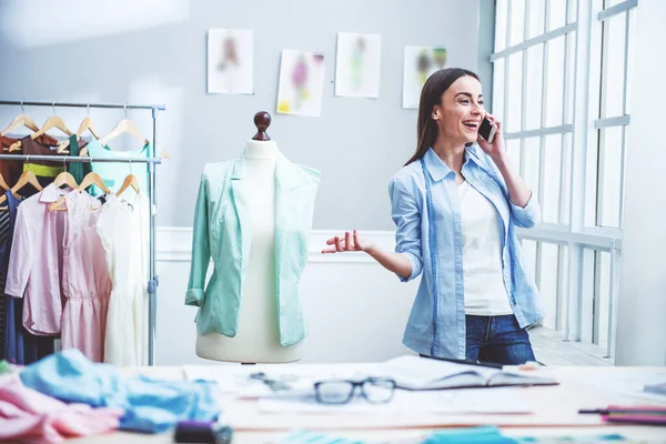 Beautiful Young Designer Talking Mobile Phone Smiling While Standing Dressmaking — Stock Photo, Image