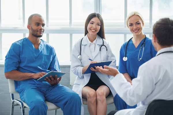 Medical Doctors Different Nationalities Genders Making Notes Talking Smiling Sitting — Stock Photo, Image