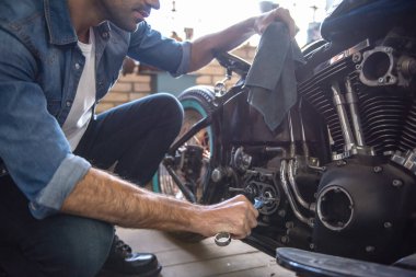 Çekici bir adam bir motosiklet tamircisi onarıyor