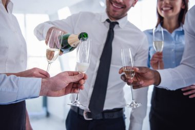 Şampanya içmek, konuşmak ve ofiste süre kutlama gülümseyen başarılı iş adamları kırpılmış görüntü