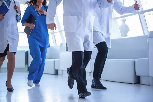 Cropped image of doctors running for help through the hospital hall