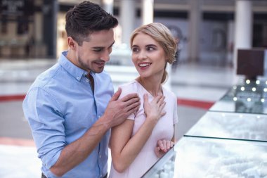 Güzel çift takı alışveriş merkezi seçerken gülümsüyor