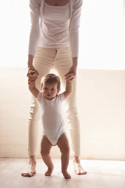 Cropped image of beautiful mom stepping with her cute baby