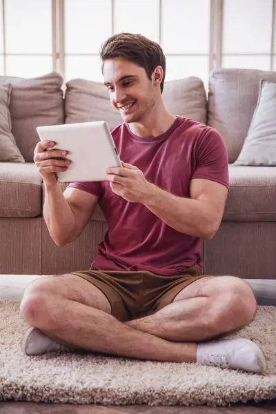 Handsome Guy Casual Clothes Using Digital Tablet Smiling While Sitting — Stock Photo, Image