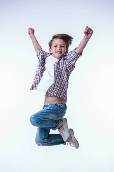 Handsome Little Boy Jumping Looking Camera Smiling Light Background Stock Photo