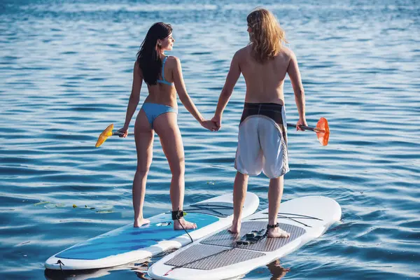 Beautiful Young Couple Holding Hands Looking Each Other While Sup — Stock Photo, Image