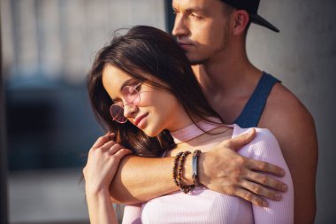 Şık genç çift şehirde yürürken sarılma