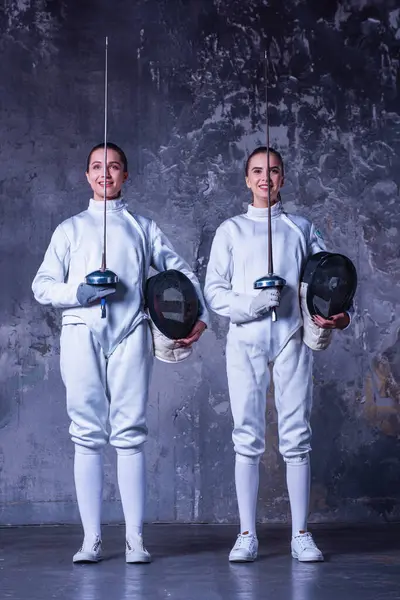 Beautiful Female Fencers Protective Clothing Holding Masks Weapon Smiling Dark — Stock Photo, Image