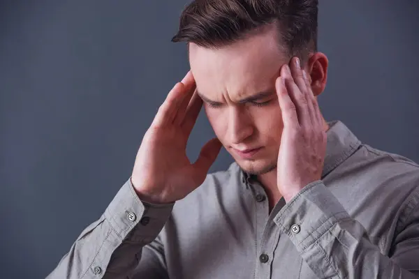 Tired Young Businessman Smart Shirt Massaging His Temples Gray Background — Stock Photo, Image