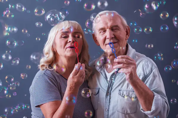 Beautiful Old Man Woman Casual Clothes Blowing Soap Bubbles Smiling — Stock Photo, Image