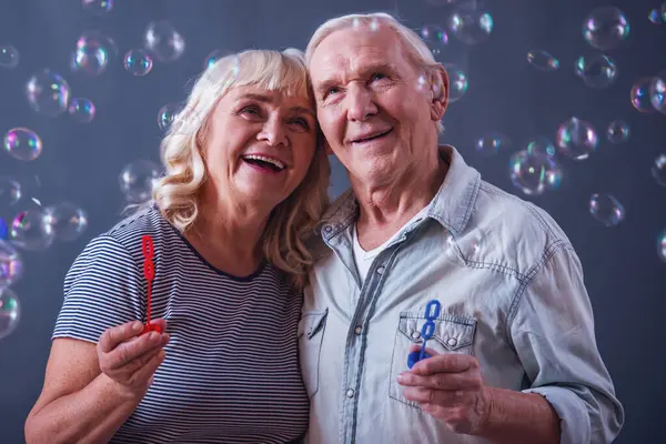 Beautiful Old Man Woman Casual Clothes Blowing Soap Bubbles Hugging — Stock Photo, Image