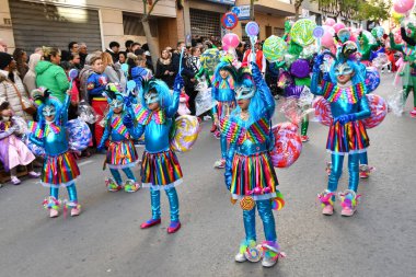 TORREVIEJA, SPAIN  FEBRUARY 12, 2023 Kids in a colorful carnival costumes at a festive parade, Alicante, Costa blanca region. Spain