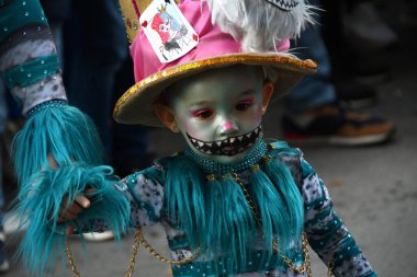 TORREVIEJA, SPAIN  FEBRUARY 12 2023 Close up portrait of a kid in a colorful carnival costume at a festive parade, Alicante, Costa blanca region. Spain