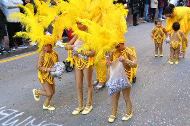 TORREVIEJA, SPAIN FEBRUARY 12, 2023: Kids in a colorful carnival costumes at a festive parade, Alicante, Costa blanca region. Spain