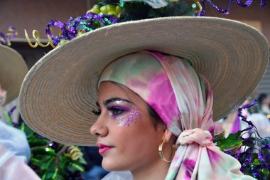 TORREVIEJA, SPAIN FEBRUARY 12, 2023: Participants dressed in a colorful carnival costumes on the street during the traditional Mardi Gras parade in Spain