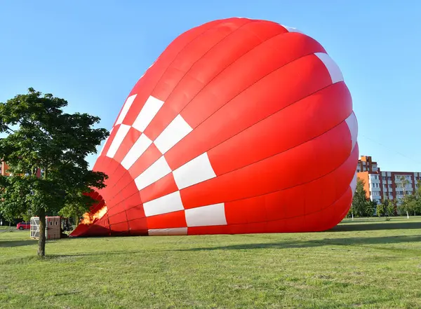 stock image Hot air balloon is inflating before liftoff in the city park