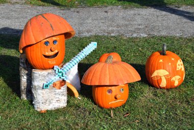 Funny mushrooms made of carved pumpkins for Halloween. Autumn  outdoor decoration clipart