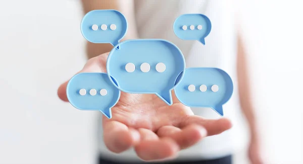 デジタル青いスピーチの泡を使用してビジネスマンはアイコンを話す ユーザーの手に浮かぶ最小限の会話やソーシャルメディアメッセージ 3Dレンダリング — ストック写真