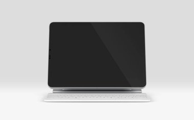 PARIS - Fransa - 28 Nisan 2022: Beyaz sihirli klavyeli Apple Ipad Pro Silver rengi, Gri arkaplanda ön ekran tableti modeli