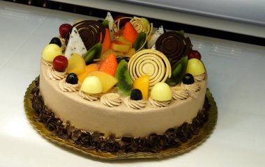  Close-up view of decorated cake in refrigerated display unit of a bakery shop                                
