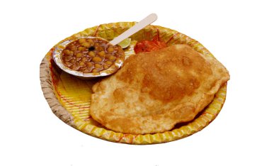 Close-up view of Indian street food Puri,curry,pickle and onion in a disposable plate                               