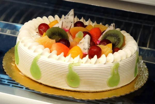   Close-up view of decorated cake in refrigerated display unit of a bakery shop                               