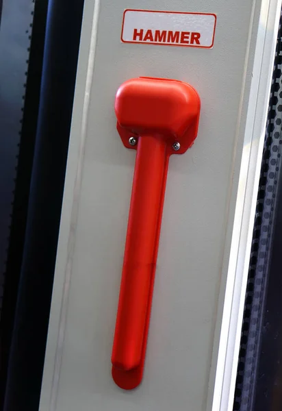 Close-up of hammer for breaking windows in emergency after traffic accident of public transport bus