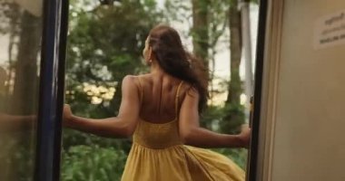 Travel and Exploration of Tourist Woman by Train to Famous Landmarks in Sri Lanka. Romantic young traveler woman enjoying extreme fun train ride from Ella to Kandy among rainforest in the highlands of