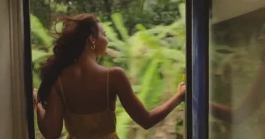 Travel and Exploration of Tourist Woman by Train to Famous Landmarks in Sri Lanka. Romantic young traveler woman enjoying extreme fun train ride from Ella to Kandy among rainforest in the highlands of