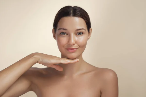 韓国の化粧スタイルで顔に触れ ベージュの背景に完璧な肌を持つ若いアジアの美容女性 顔の治療 プラスチック手術 高品質のスタジオ写真 — ストック写真