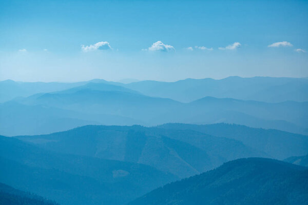 Abstract mountain background - concept of tourism and mountaineering. Layers of ridges in Carpathians Mountains Ukraine at sanrise sky
