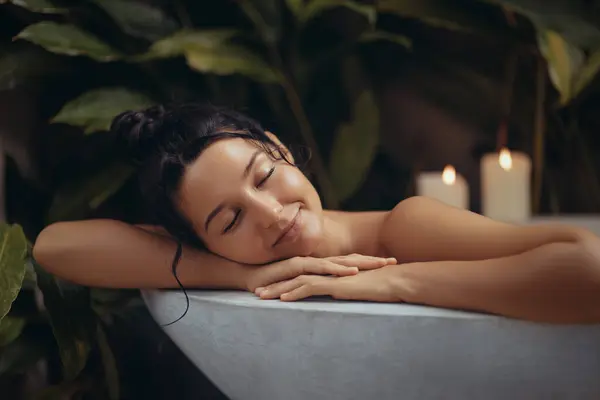 Home Spa Relax. Beauty portrait of smiling young female resting in bathtub with closed eyes, attractive millennial woman relaxing in modern bathroom interior , happy lady enjoying taking hot bath