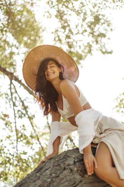 Joyful Woman Wearing Straw Hat Summer Attire Sitting Tree Branch Stock Picture