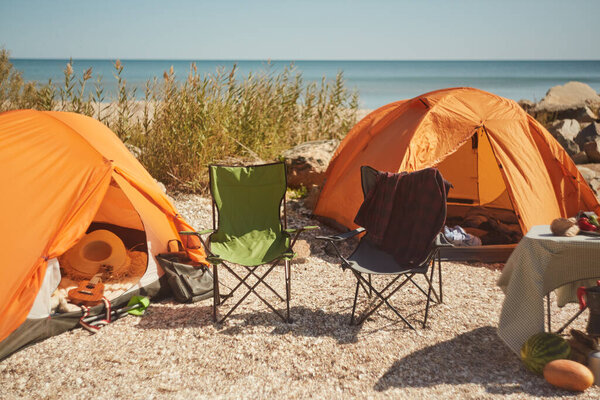 Two Empty Camping Chairs Set Orange Tents Beachside Campsite Awaiting Royalty Free Stock Images