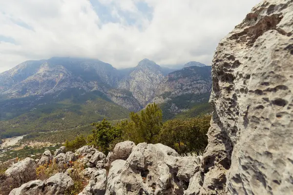 stock image A stunning view of majestic mountains with rugged rocky terrain in the foreground in Antalya, Turkey. Ideal for travel, adventure, and nature-themed projects highlighting natural landscapes.