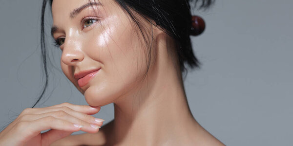 Elegant portrait of an Asian woman with glowing skin and natural makeup. Perfect for beauty, skincare, and cosmetics promotions, showcasing high-quality and natural beauty concepts. 