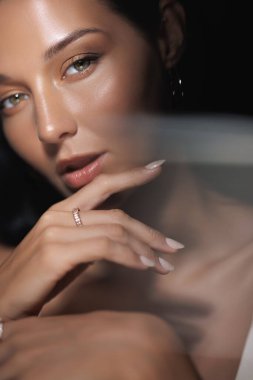 A close-up portrait of a woman with flawless skin and soft makeup, illuminated by reflective light. This image is perfect for beauty, skincare, and cosmetic promotions or lifestyle content. clipart