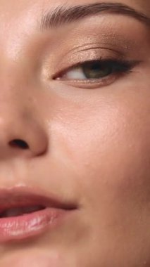 Son derece yakın plan, gösterişli altın göz makyajı ve yumuşak ışıkta parlayan cilt. Güzellik, kozmetik ve lüks makyaj kampanyaları için ideal. Zarafet ve detayı vurgulayan kampanyalar.. 