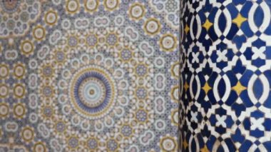 Moroccan zellige mosaic pattern in traditional Islamic geometric design in Morocco. Made with natural colors from indigo, saffron, mint, kohl. 4k Moroccan design background footage changing focus foreground to background.  