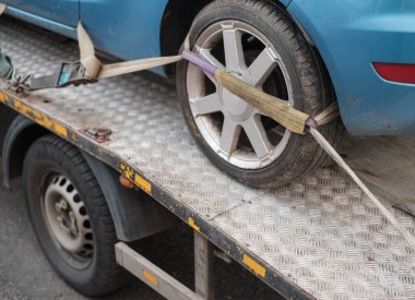 A Car Being Towed After A Parking Violation Or Breakdown clipart