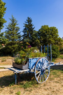 blue wooden cart with flowers in Provence, France