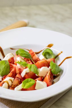 tomato salad with mozzarella, basil and balsamic cream